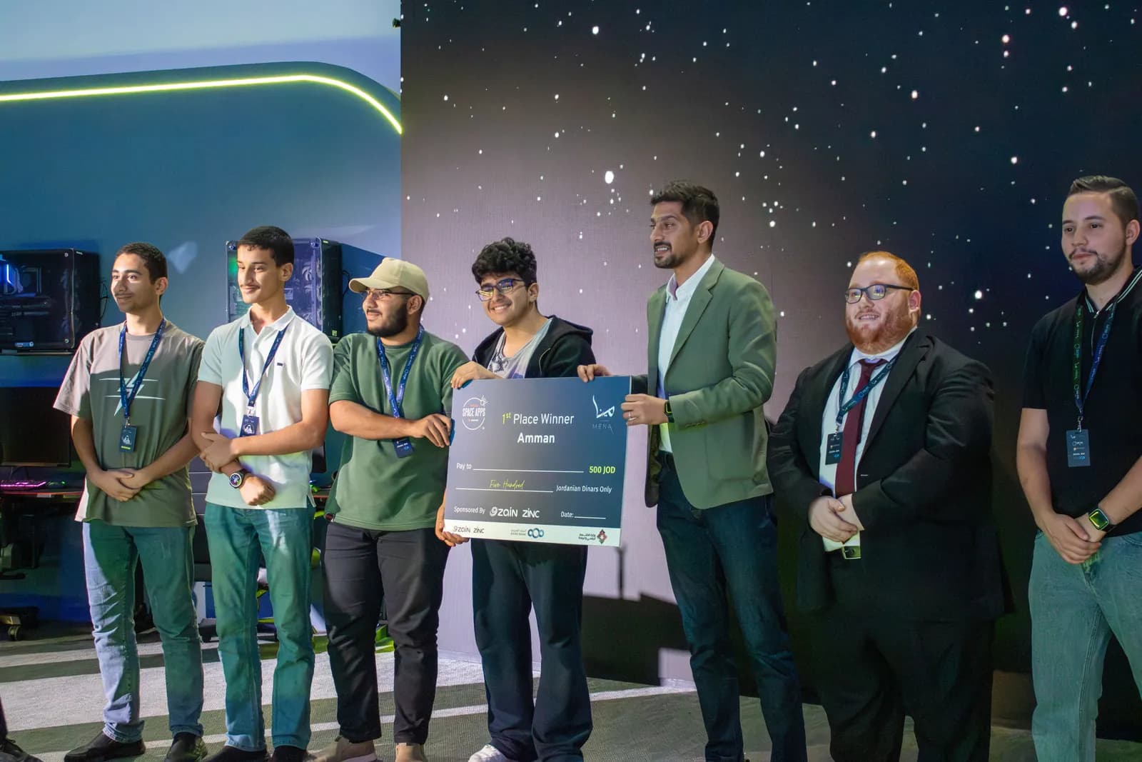 A winning team receiving their award on stage at the 2025 event