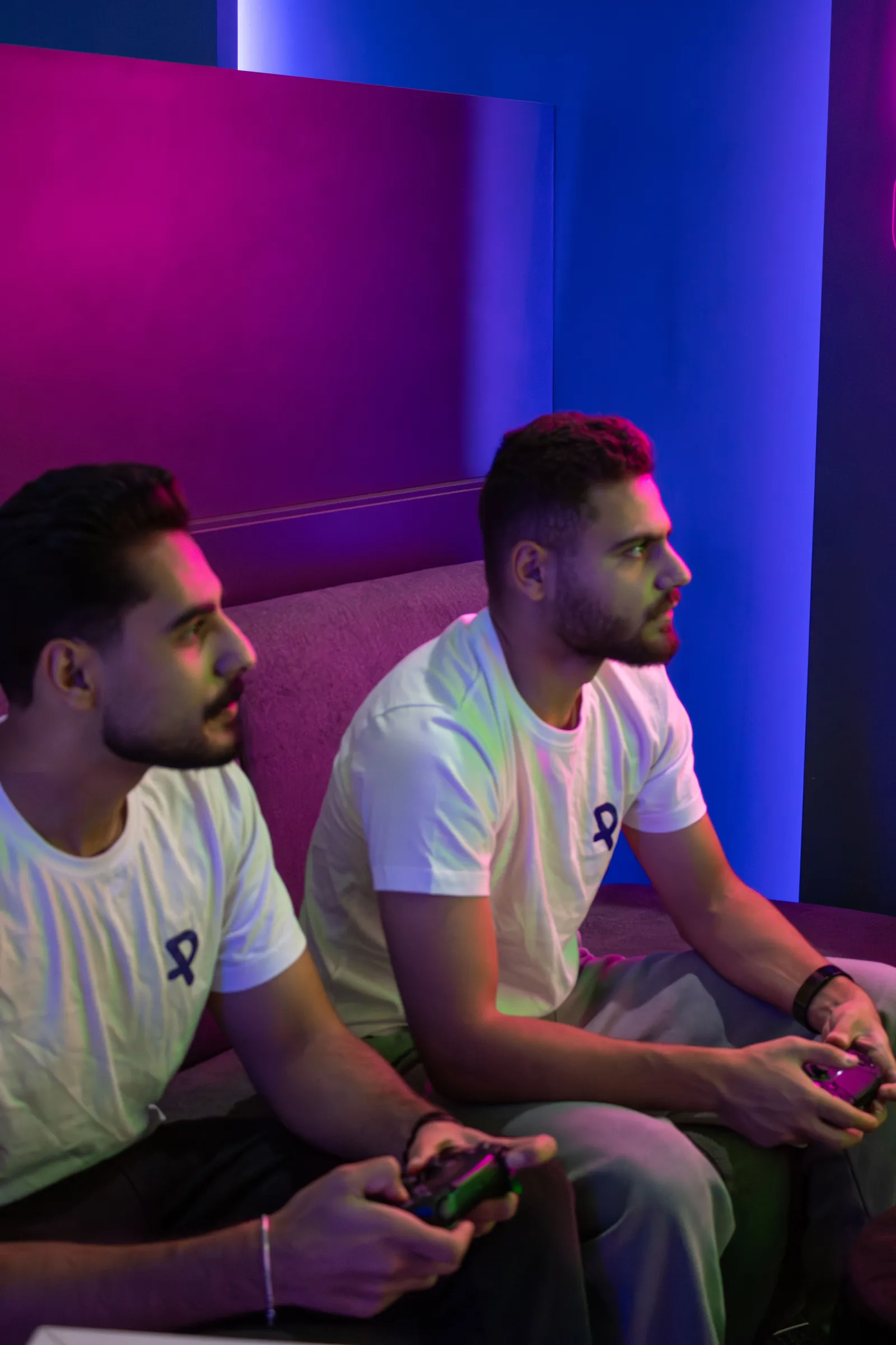 Two participants side by side under coloured lighting